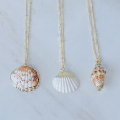 Dive into the deep blue of summer fashion with these gorgeous gold seashell necklaces! Walk the beach in style with perfect accessories that blend the beauty of the sea with the luxury of shimmering gold. Wave goodbye to basic jewelry and make a statement with these stunning necklaces! Gold-detailed seashell charms on a 14k gold plated satellite chain. Necklaces are 16 inches in length and include a 2-inch extender. Gold Seashell Necklace, Seashell Necklaces, Shells Jewelry, Wave Goodbye, Seashell Jewelry, Basic Jewelry, Necklaces Gold, Seashell Necklace, Mermaid Necklace