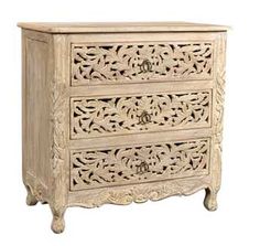 an ornate carved wooden cabinet with drawers