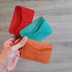 The ideal leather card sleeve that perfectly fits in your pocket or bag for everyday use.  This slim card holder is made from genuine calf leather of vibrant colours. The card case has two slots  that easily fit 2-4 cards. The stitching is made with a strong thread for leather. Dimensions: 7 x 10 cm ( 2.36 x 3.94 inches) Available colours: ocher, yellow, pink, light pink, green, mint green, light blue, blue, red, peach, burgundy and purple. ADD PERSONALISATION I stamp the initials/name/date/text Everyday Red Card Holder With Rfid Blocking, Red Card Holder With Interior Slots For Everyday Use, Everyday Red Card Holder With Card Slots, Red Leather Everyday Card Holder, Everyday Red Card Holder With Slots, Classic Red Card Holder For Gift, Red Card Holder With Interior Slots For Gift, Red Leather Card Holder For Daily Use, Red Bifold Card Holder For Gift