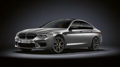 the new bmw m5 grano is shown in an image taken from behind on a dark background