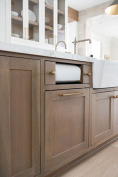 a kitchen with wooden cabinets and white counter tops