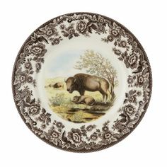 a plate with an animal painted on it's side and flowers around the edge