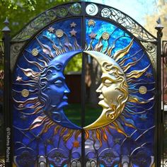 the sun and moon are depicted in this metal gate