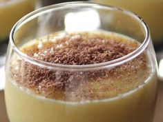 a close up of a drink in a glass on a table with other food items