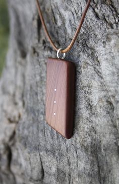 "Adorned with Sterling silver inlays, this outstanding and unique hand-carved 6000 year old Irish Bog Yew pendant has been made for you, or a loved one, in my studio on the West of Ireland. Bog Yew comes from ancient forests that once covered Ireland. Huge Yew trees have been buried in peat bogs and preserved from decay by the acidic and anaerobic bog conditions, sometimes for hundreds or even thousands of years. The wood is usually stained brown by tannin dissolved in the acidic water. Bog-wood Brown Wooden Pendant Jewelry, Nature-inspired Wooden Pendant Jewelry, Spiritual Wood Jewelry For Gifts, Carved Natural Wood Jewelry, Walnut Wood Jewelry Gift, Carved Wood Jewelry, Peat Bog, Celtic Knot Necklace, Yew Wood