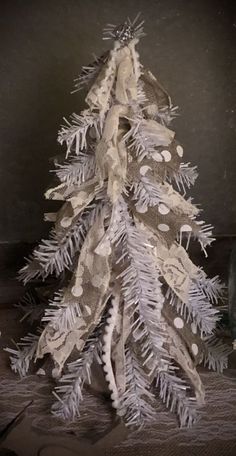 a white christmas tree sitting on top of a table