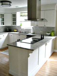 a kitchen with white cabinets and an island