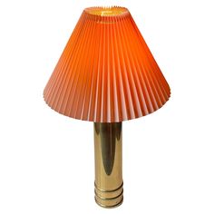 an orange lamp sitting on top of a table