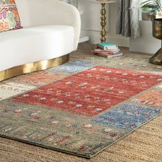 a living room area with a couch, chair and rug