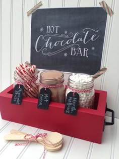 hot chocolate bar in a red box with chalkboard sign and candy canes on the side