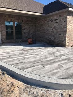 a concrete patio being built in front of a house