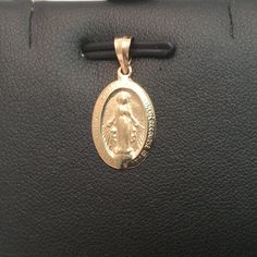 14k Yellow Real Solid Gold Oval Virgin Mary Miraculous Medal Charm Pendant .9gr Metal Type: 14k Solid Yellow Real Gold Weight: .90 Grams Width: 10 Mm Wide Length: 3/4 Inches Long With Bail Comes With A Gift Box Retail $869.00 Oval Rose Gold Charms Jewelry, Yellow Gold Round Miraculous Medal Jewelry, Classic Oval Pendant Jewelry With Charms, Yellow Gold Miraculous Medal Jewelry, 14k Gold Oval Charms Jewelry, 14k Gold Charms Jewelry, Oval 14k Gold Charms Jewelry, Oval White Gold Jewelry With Charms, Hallmarked Rose Gold Oval Jewelry