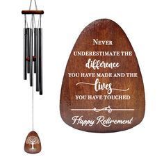 a wooden wind chime with an inspirational quote on the front and back of it