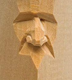 a wooden carving of a man's face with his eyes closed