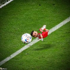 a soccer player is diving for the ball