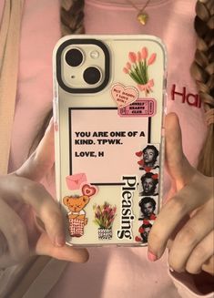 a person holding up a phone case with pictures on the front and back of it