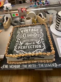 a cake that is sitting on top of a table in front of some other items