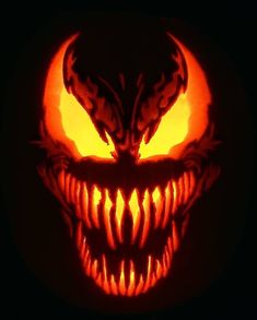 a pumpkin with an evil face carved into it's mouth and fangs on the inside