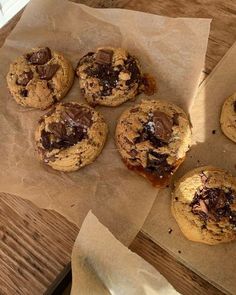 chocolate chip cookies sitting on top of brown paper