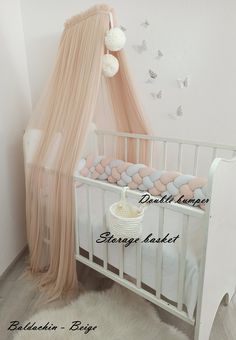 a white crib with a pink canopy over it