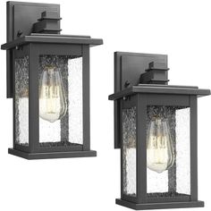 two light outdoor wall sconces with clear glass panels and black metal frame, one is