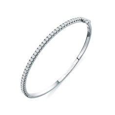 From the Lennon Collection, the Petite Diamond Bangle Bracelet features French set brilliant cut diamonds across the top half of this hinged bangle. Wear on its own or add to your current bracelet stack for an effortless yet sophisticated look. - Total Carat Weight: (Size 2) 0.50 - 2.0 mm wide - Design Number: P05B001 Please note that the carat weight and number of stones will vary based on the size of the creation you order. For detailed information please contact us. Every piece of our jewelry Timeless Bangle With Pave Setting For Formal Occasions, Classic Diamond Pave Bangle Bracelet, Minimalist Brilliant Cut Bangle For Formal Occasions, Timeless Bangle With Pave Setting, Classic Pave Setting Bangle For Formal Events, Classic Pave Setting Bangle For Formal Occasions, Classic White Gold Diamond Bracelet With Pave Setting, Classic Bangle With Pave Setting For Formal Occasions, Formal Pave Setting Diamond Bangle Bracelet