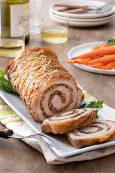 sliced meatloaf with carrots and wine on the side