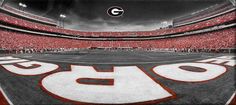 a stadium filled with lots of red and white football field covered in fans watching the game