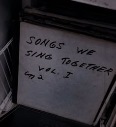 a sign that says songs we sing together, vol i on the side of a refrigerator