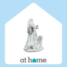 a figurine of a woman with a dog on her lap and the words at home above it