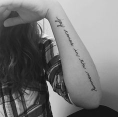 a woman with a tattoo on her arm that says, i love you to the moon and back