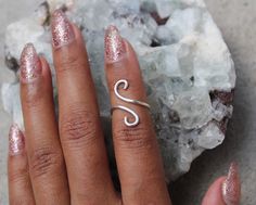 "This listing is for one (1) unique and eye-catching statement ring. The Silver Coiled Midi Ring can be ordered in any normal ring size or midi ring size. Your choice of Silver Plate or Sterling Silver wire is hand shaped in a \"S\" formation, and looks great alone and paired with other rings or alone. Due to the open shape, the ring is slightly adjustable, and great to give as a gift! Specify ring sizes during checkout: An unspecified order will revive a most midi ring size 3/4 Nickel free." Modern Twist Adjustable Midi Rings As Gift, Adjustable Midi Rings With A Modern Twist For Gifts, Silver Spiral Midi Rings As Gift, Handmade Spiral Minimalist Rings, Handmade Minimalist Spiral Rings, Minimalist Handmade Spiral Rings, Hand Wrapped Spiral Rings As Gift, Midi Rings Silver, Midi Ring