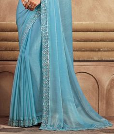 COLOR : Sky Blue FABRIC : Saree - Chiffon Silk, Blouse - Chiffon Silk & Net WORK : Resham Embroidery, Stones, Sequins, Lace BorderOCCASION : Wedding, Engagement, Party Wear, Festival, Sangeet NOTE : The outfit includes blouse and saree only. Petticoat is not included. READY-TO-WEAR : No STITCHING : Available as semi-stitched fabric, can be stitched using standard size option (+$30). Note: There might be a slight color variation due to lighting and flash used during photoshoot. The bright shade s Blue Georgette Saree With Embroidered Border, Georgette Embroidered Fabric For Reception, Blue Embroidered Georgette Blouse Piece, Fitted Blue Embroidered Art Silk Fabric, Blue Embroidered Georgette Saree, Blue Semi-stitched Georgette Embroidered Fabric, Semi-stitched Blue Georgette Embroidered Fabric, Light Blue Georgette Saree With Zari Work, Blue Semi-stitched Saree With Embroidered Border