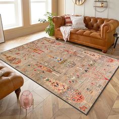 a living room with a couch, chair and rug