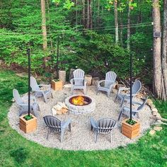 an outdoor fire pit with chairs around it