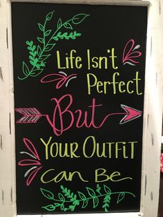 a chalkboard sign that says, life isn't perfect but your outfit can be