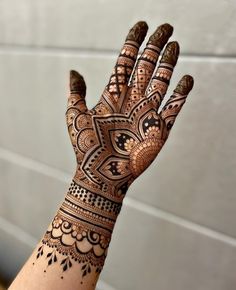 a person's hand with henna tattoos on it