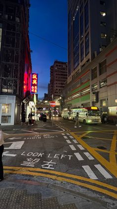 a person walking across a street at night