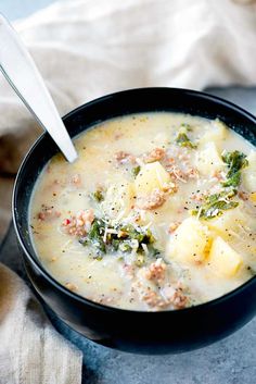 a close up of a bowl of soup with broccoli