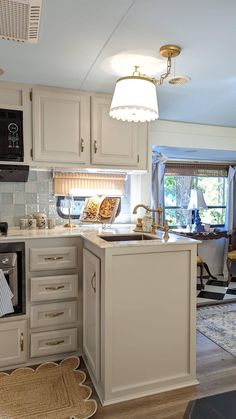 a kitchen with white cabinets and an island