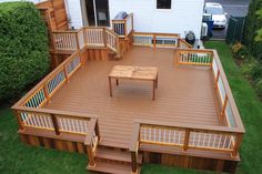 a wooden deck with benches and tables on it