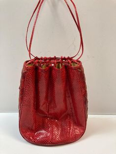 Beautiful red snakeskin handbag by Barbara Bolan for Bolan Too, featuring a drawstring closure and cross woven side panels. Shipped within 1-2 business days. Red Bucket Bag With Top Carry Handle, Red Bucket Bag With Braided Handles For Shopping, Red Bucket Bag With Braided Handles, Snake Skin Handbag, Drawstring Purse, 90s 80s, Side Panels, Panel Siding, Wedding Shop