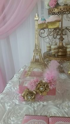 a table topped with pink and gold decorations