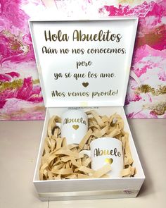 two coffee mugs in a gift box with spanish words