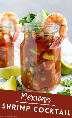 two mason jars filled with salsa and shrimp, garnished with cilantro