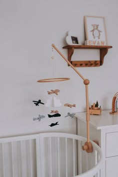 a baby crib with an airplane mobile hanging from it's side