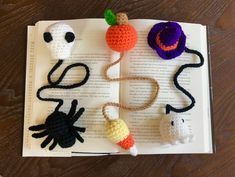 crocheted halloween decorations on top of an open book