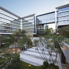 an office building with many windows and people walking around