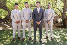 a group of men in suits standing next to each other