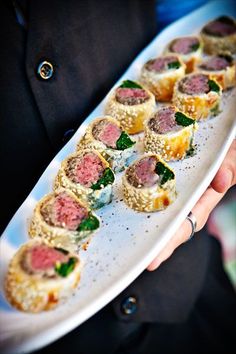 a person holding a plate with some food on it